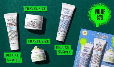 A graphic, set against a dark green textured background, features four Kiehl’s products and a gift box. A white tube of "KIEHL’S ULTRA BODY MEGA MOISTURE SQUALANE CREAM" is labeled "DELUXE SAMPLE" in bright green. A white jar of "KIEHL’S ULTRA FACIAL CREAM" is labeled "TRAVEL SIZE" in bright green. A white tube of "KIEHL’S ULTIMATE STRENGTH HAND SALVE" is labeled "DELUXE SAMPLE" in bright green. A small open white jar of "KIEHL’S CREAMY EYE TREATMENT WITH AVOCADO" with visible pale yellow cream is labeled "TRAVEL SIZE" in bright green. In the lower right, a blue Kiehl’s gift box showcasing the same four products is visible, decorated with bright green graphic paint splatters and a bow design