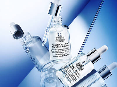 Seruri Kiehl's pentru corectarea petelor intunecate, prezentate pe un fundal albastru elegant.