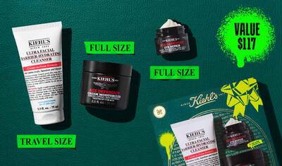 A graphic set against a dark green textured background with bright green accents features three Kiehl’s products and a gift box. On the left is a white tube of "KIEHL’S ULTRA FACIAL BARRIER-HYDRATING CLEANSER" labeled "TRAVEL SIZE." In the center are a black jar of "KIEHL’S AGE DEFENDER CREAM MOISTURIZER" and a black jar of "KIEHL’S AGE DEFENDER EYE REPAIR" with visible cream, both labeled "FULL SIZE." To the right is a boxed Kiehl’s gift set displaying the same three products, decorated with bright green graphic shapes and a bow design."