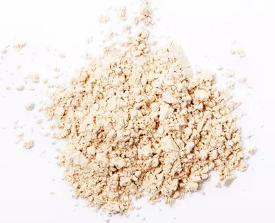 A light-colored powder spread out on a white surface.
