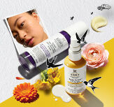 Un banner cu un peisaj in natură, cu o patură de picnic in carouri albe și roșii pe o pajiște verde, iar in partea de sus cu vedere la cer. In dreapta, sunt așezate pe pătură cele trei mini produse incluse in campanie.