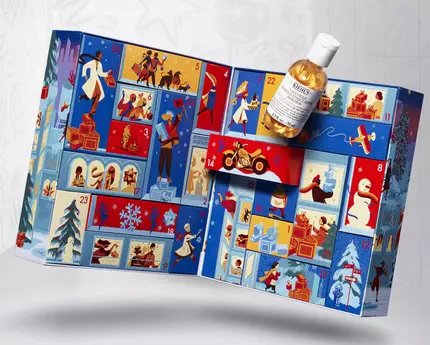 Un calendar advent cu ilustrații colorate și o sticlă plasată deasupra.